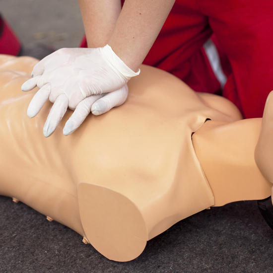 Person administering CPR on a manikin